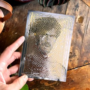 An image of a gift card from the front. A tintype portrait is overlaid with a gold victorian lace design from a historic tintype case.